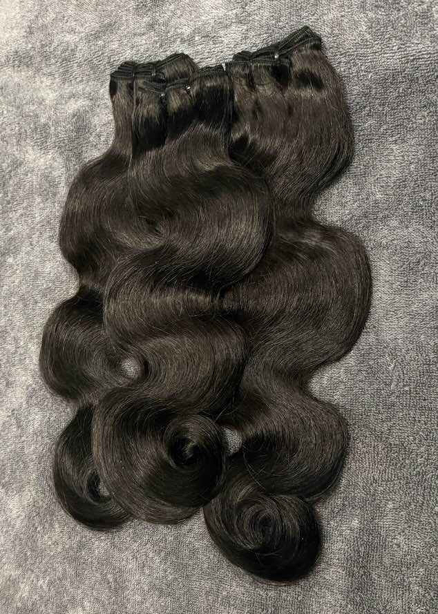 Three bundles of Human hair in body wavy piled together