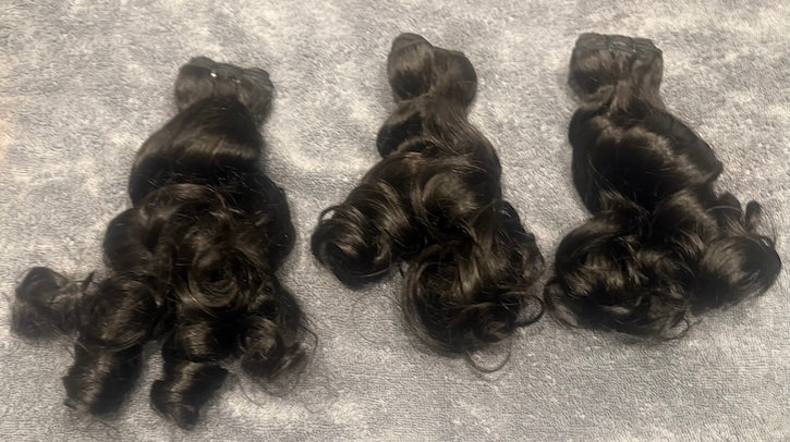 Beautiful Three bundles of human hair natural loose curl