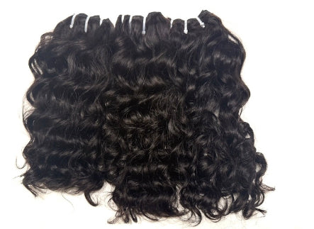 Three bundles of Brazilian Black loose  curly human hair extensions on a white background