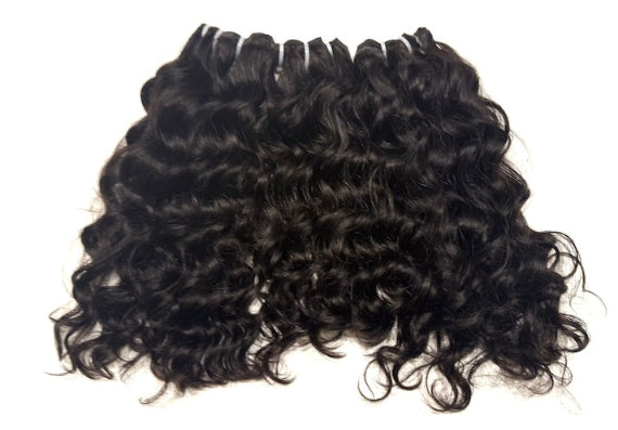 Three bundles of Black curly hair extensions on a white background