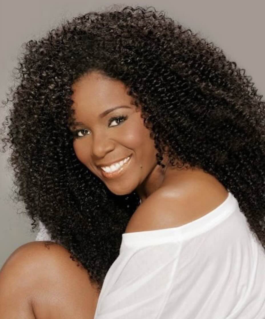 beautiful woman wearing Brazilian curly hair extensions