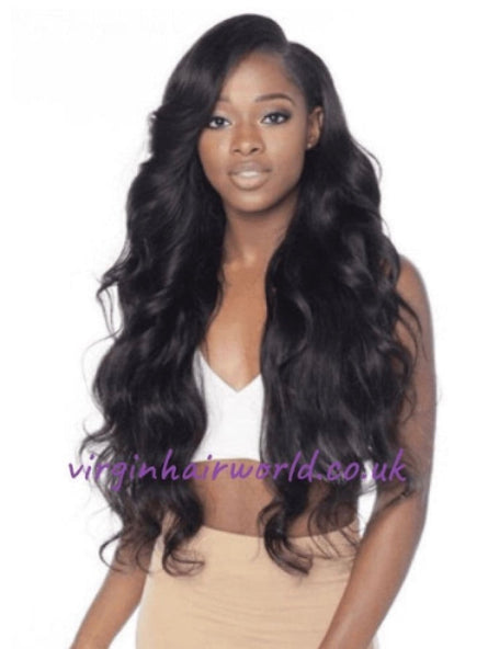 A smiling afro Caribbean woman wearing human hair extension of Brazilian body wavy style